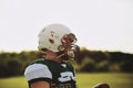 Football quarterback standing on a sports field holding a ball Royalty Free Stock Photo