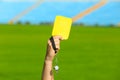 Football referee holding yellow card and whistle at stadium Royalty Free Stock Photo