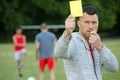 Football referee showing yellow card Royalty Free Stock Photo