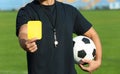 Football referee showing yellow card at stadium Royalty Free Stock Photo