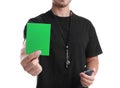 Football referee with stopwatch and whistle holding green card on white background Royalty Free Stock Photo