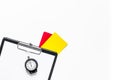 Football refereeing. Yellow and red referee cards, stopwatch, pad, on white background top view copyspace Royalty Free Stock Photo