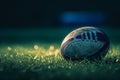 A football rests on the vibrant green surface of a well-maintained field, Close-up of a rugby ball on a green field with dramatic