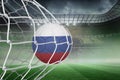 Football in russia colours at back of net Royalty Free Stock Photo