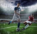 Football scene with competing football players at the stadium Royalty Free Stock Photo