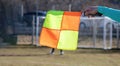 Football soccer arbiter assistant with flag at hands