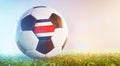 Football soccer ball with flag of Costa Rica on grass Royalty Free Stock Photo