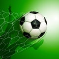 Football soccer ball flying into the goal net with a player Royalty Free Stock Photo