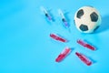 Football, soccer ball near syringe and ampoule on blue background. Concept of doping in professional sport Royalty Free Stock Photo