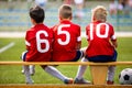 Football soccer children team. Kids substitute players sitting on a bench Royalty Free Stock Photo