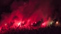 Football soccer fans hooligans lit up the lights, torches, flares and smoke bombs. Protest or revolution concept background. Red s