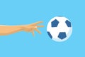 Football / Soccer Flying Ball on Blue Background. Hand Reaching for Ball.