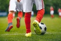 Football/Soccer Running with the Ball.Close-up View of Soccer Ball and Player Leg