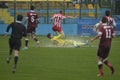 Football or soccer tackle on flooded field