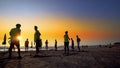 Football sport team is engaged in jogging at sunset