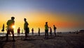 Football sport team ready for jogging on the beach at sunset