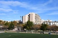Football stadium in the city park in Valencia. View of a sports stadium with a green lawn against the backdrop of residential buil Royalty Free Stock Photo
