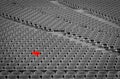 Football stadium with empty seats. Outstanding empty red plastic chair at soccer arena. Row of unoccupied bench at sports stadium. Royalty Free Stock Photo