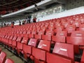 An empty rows of plastic seats in football stadium. Best observed from the side Royalty Free Stock Photo