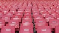 An empty rows of plastic seats in football stadium. Best observed from the front side Royalty Free Stock Photo