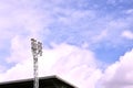 Football stadium lamp structure on blue sky background in sunny day