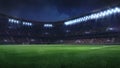 Modern football stadium illuminated by floodlights and empty green grass