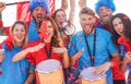 Football supporter fans cheering with confetti watching soccer match event at stadium - Young people group with having excited fun Royalty Free Stock Photo