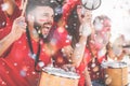 Football supporter fans cheering with confetti watching soccer match event at stadium - Young people group with having excited fun Royalty Free Stock Photo