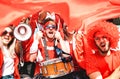 Football supporter fans cheering with flag watching soccer cup match at stadium tribune Royalty Free Stock Photo