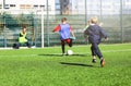 Football team - boys in red and blue, green uniform play soccer on the green field. Team game, training, active lifestyle