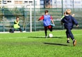 Football team - boys in red and blue, green uniform play soccer on the green field. Team game, training, active lifestyle, hobby, Royalty Free Stock Photo