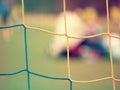 Football training. Crossed soccer nets soccer football in goal net with grass Royalty Free Stock Photo