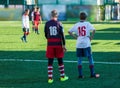 Football training soccer for kids. Boy runs kicks dribbles soccer balls. Young footballers dribble and kick football ball in game. Royalty Free Stock Photo