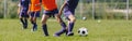 Footballers on Football Training Camp. Young Players Kicking Soccer on Practice Session