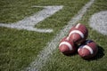 Footballs on a playing field Royalty Free Stock Photo