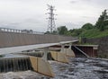 Footbridge crossing the flood alleviation weir on the river aire at knostrop leeds with electricity pylons in a rural industrial Royalty Free Stock Photo