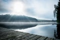 Footbridge with fog on a lake Royalty Free Stock Photo