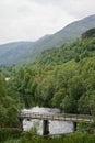 A footbridge in Glen Affric in the Scottish Highlands, with Loch Pollain Buidhe in the background Royalty Free Stock Photo