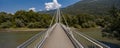 Footbridge in the middle of the forest, beautiful architecture. Below flows the crystalline Ticino river