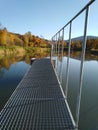 A footbridge in the middle of the lake is surrounded by a beautiful view