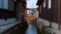 Footbridge over canal between traditional Japanese houses at dusk in Takeda, Japan Royalty Free Stock Photo