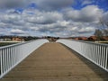 Footbridge over river and buildings in the background Royalty Free Stock Photo