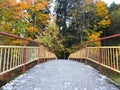 Footbridge by river Sysa in autumn, Lithuania Royalty Free Stock Photo