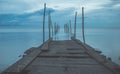 Footbridge sea beach for journey calm hormone. Wooden pier or jetty remains on a blue ocean Royalty Free Stock Photo