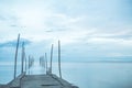 Footbridge sea beach for journey calm hormone. Wooden pier or jetty remains on a blue ocean Royalty Free Stock Photo