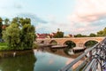 Regensburg, Germany - 26 July, 2018: Footbridge the Stone Bridge across the Danube river. Old monastery and church complex St. Man Royalty Free Stock Photo