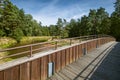 A footbridge with a wooden balustrade over the beautiful and transparent Mala Panew river, also known as the Polish Amazon. Sandy