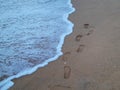 Footmark and wave foam on the beach