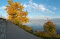 Footpath along the Lake Zurich shore with a great view of the lake and mountain landscape and fall color foliage in the foreground Royalty Free Stock Photo