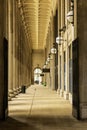 A footpath at Chicago Union Station with tall stone pillars, a man walking, round lights and black metal gate in downtown Chicago Royalty Free Stock Photo